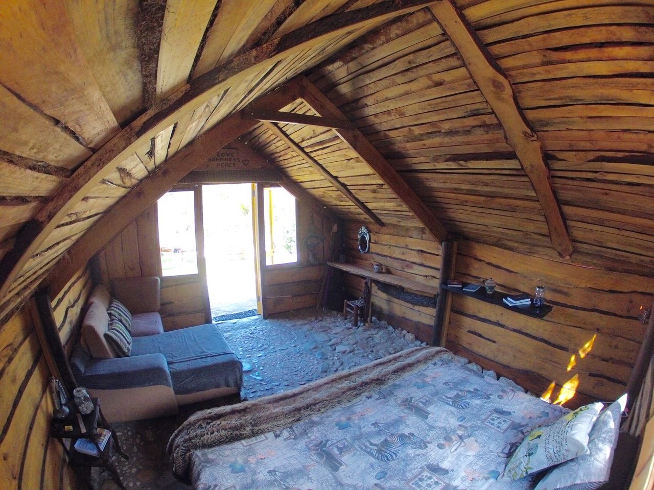 King size bed in rustic cabin.